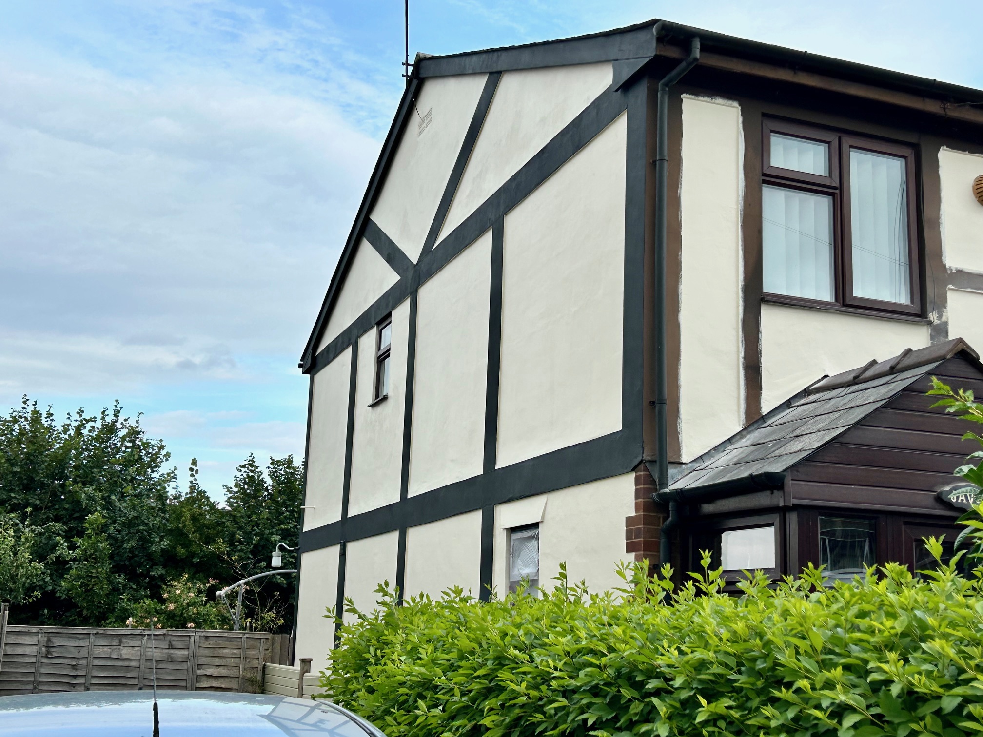 Repainted mock-Tudor timber framing on a Herefordshire house exterior