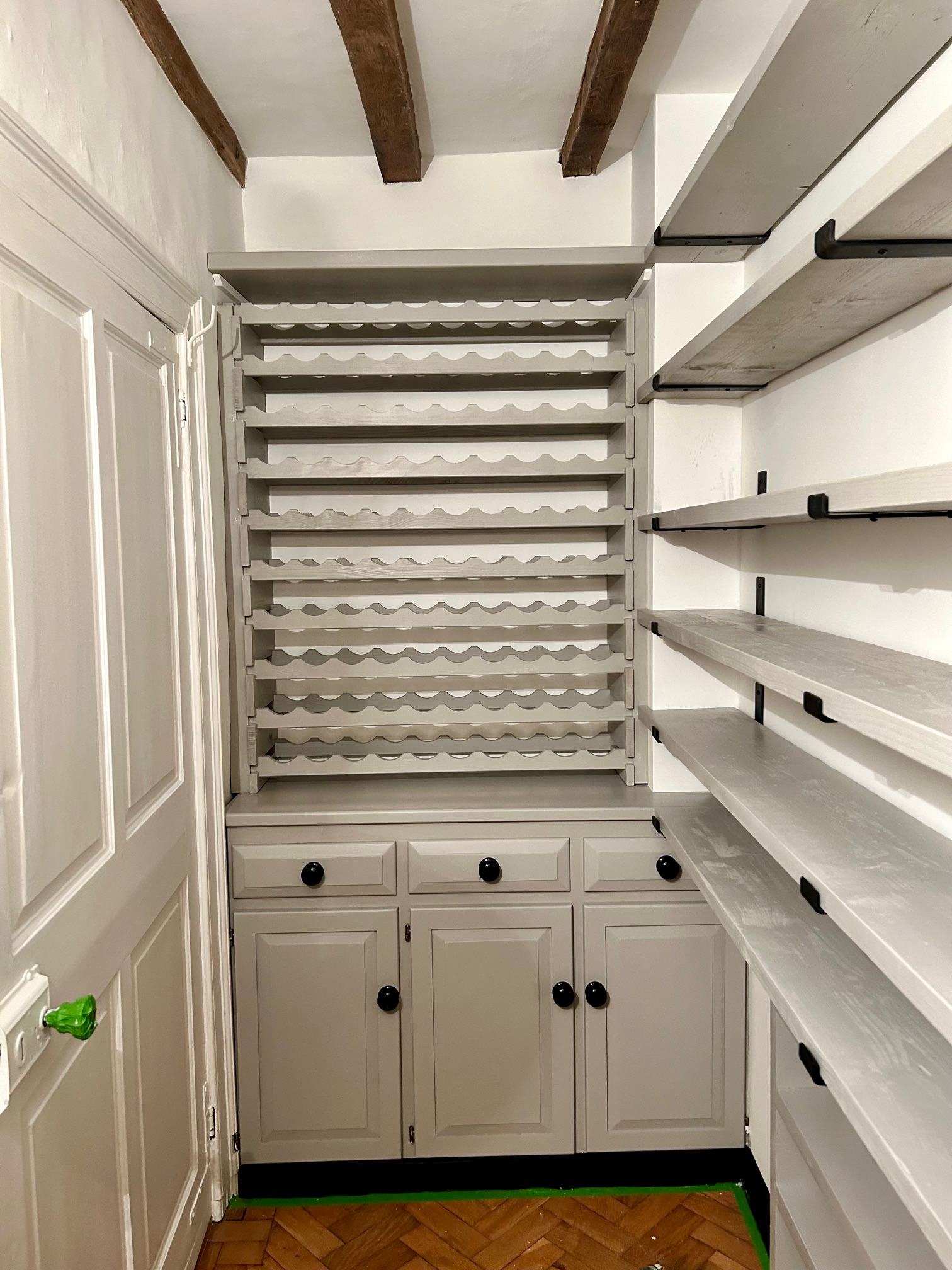 Built-in painted wine rack and pantry shelving