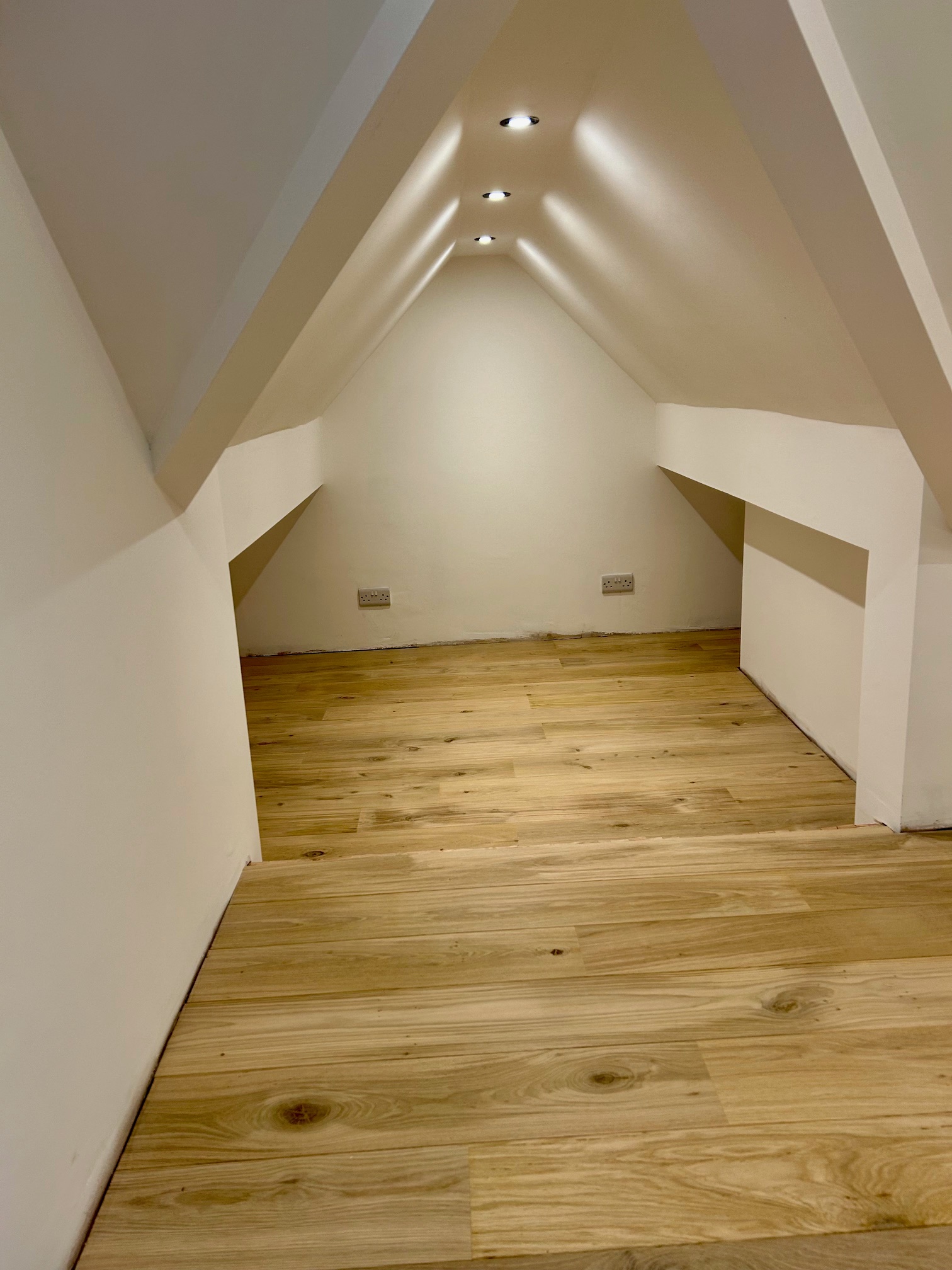 Freshly painted attic room with new oak flooring