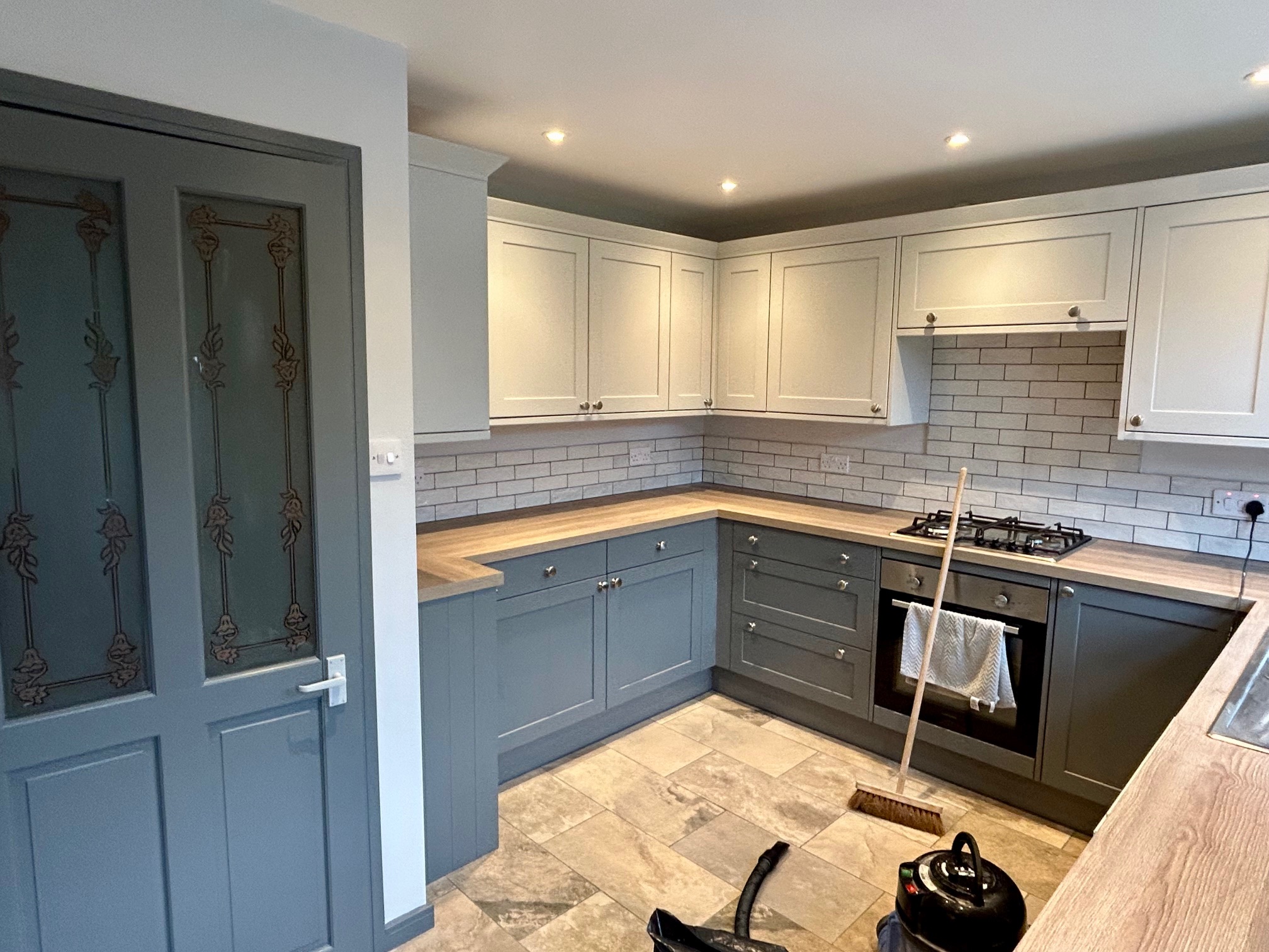 Finished shaker kitchen with two-tone cabinet paint finish