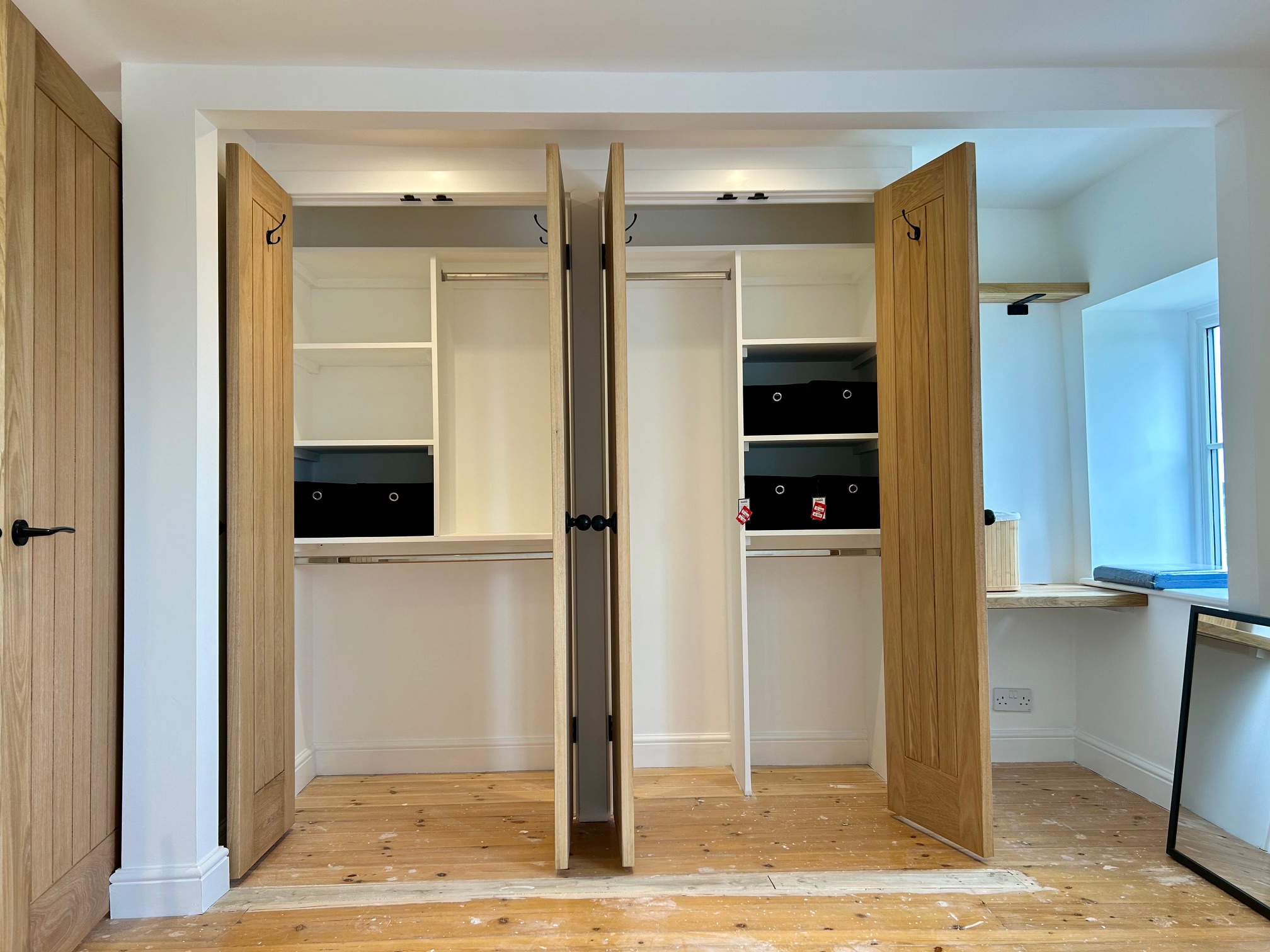 Painted built-in wardrobes with oak doors