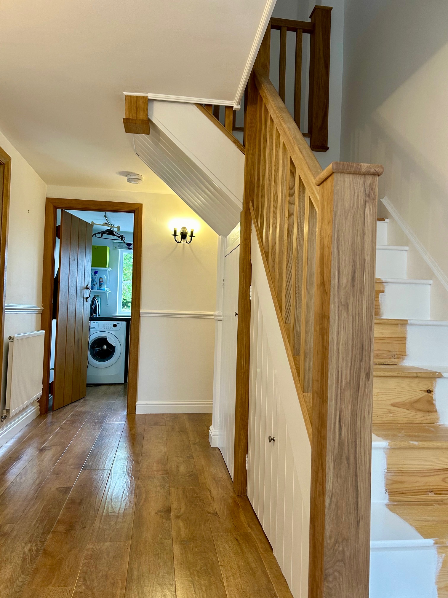 Painted staircase and hallway with oak newel post